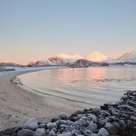 A curved beach at dusk on Kvaloya