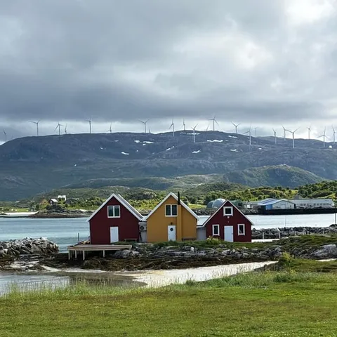 Red and yellow boathouses along the shore